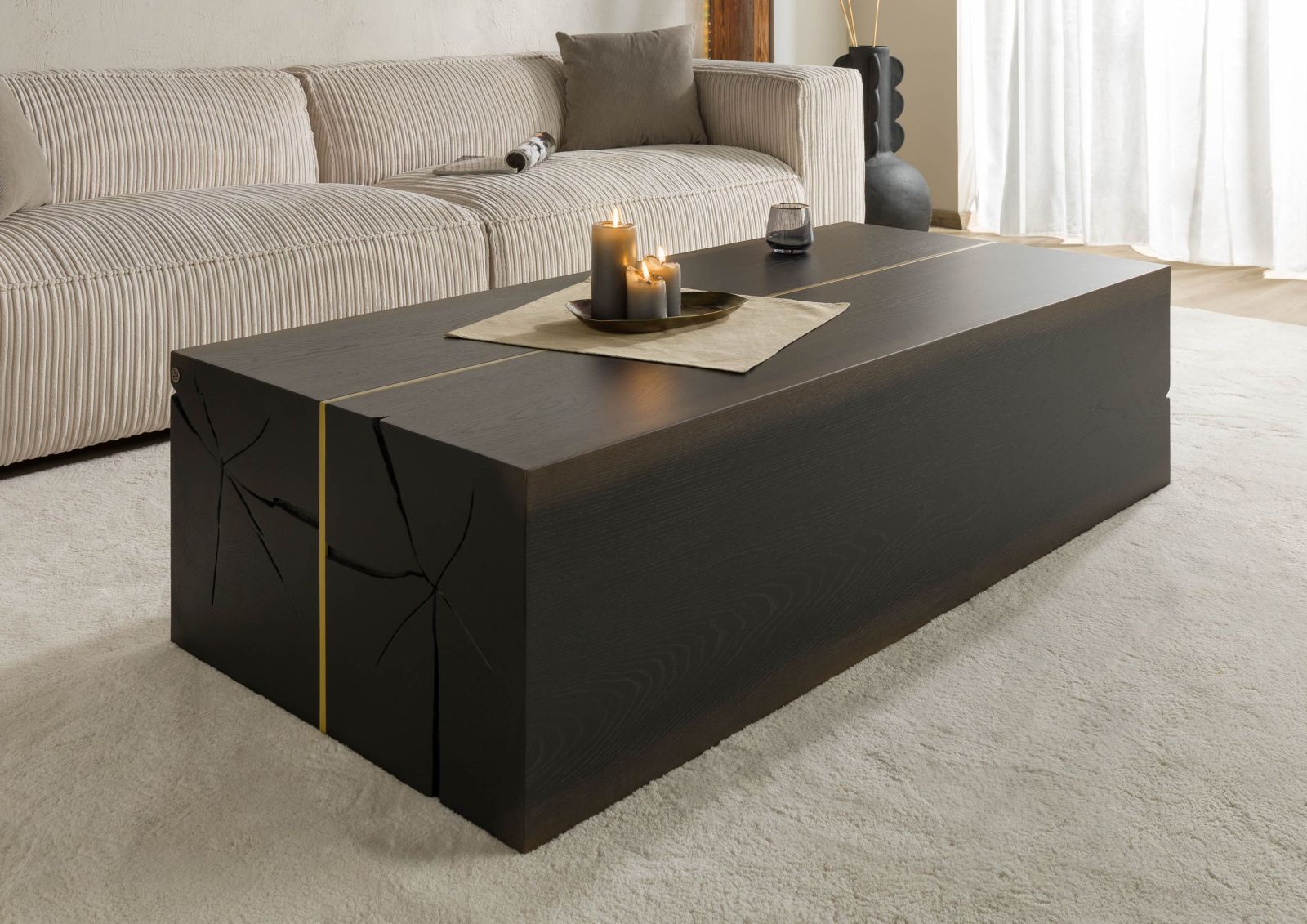Massiver Couchtisch mit Hirnholz-Furnier vor heller Wohnzimmer-Kulisse